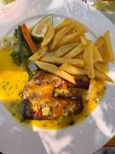 Where the wild meets refined dining services and indulgence. Freshly prepared snapper, golden fries, and vibrant gard